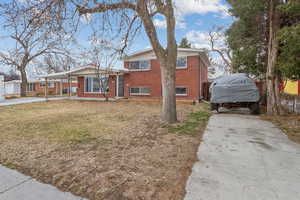 View of front of home featuring a front lawn and a carport