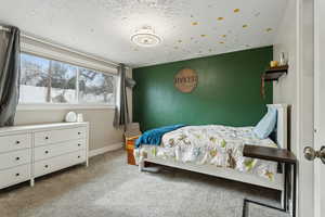 Carpeted bedroom featuring a textured ceiling