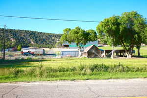 Exterior space with a rural view, a mountain view, and an outbuilding