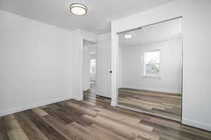 Unfurnished bedroom with a closet and wood-type flooring