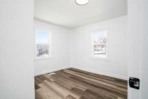 Unfurnished room with dark hardwood / wood-style flooring