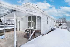 View of snow covered rear of property