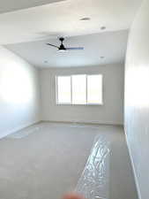 Unfurnished room featuring a textured ceiling, light carpet, baseboards, and ceiling fan