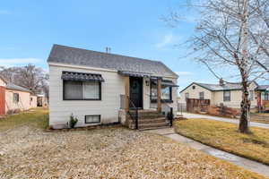 Bungalow-style house featuring a front lawn