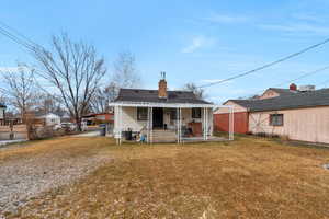 Rear view of house with a lawn