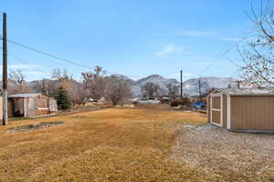 View of yard featuring a storage unit and a mountain view