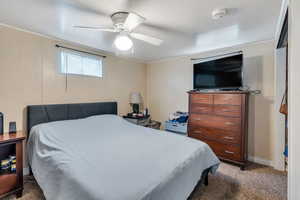 Carpeted bedroom with ceiling fan