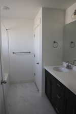 Bathroom featuring a textured ceiling and vanity