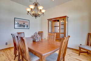 Dining room with a chandelier and light hardwood / wood-style floors