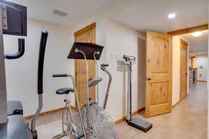 Exercise area featuring light tile patterned flooring