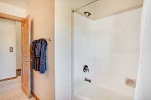 Bathroom with tile patterned floors and shower / bath combo with shower curtain