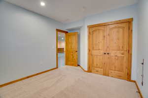 Unfurnished bedroom featuring light colored carpet