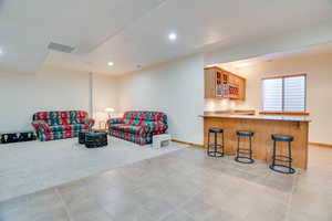 Living room featuring light carpet and indoor wet bar