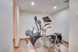 Exercise area featuring light tile patterned flooring