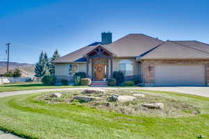 View of front facade with a garage and a front lawn