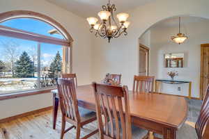 Dining room with an inviting chandelier and light wood-type flooring