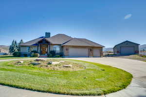 View of front of home featuring a garage and a front lawn