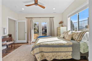 Bedroom featuring ceiling fan, access to exterior, wood-type flooring, and french doors