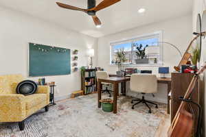 Home office with hardwood / wood-style flooring and ceiling fan