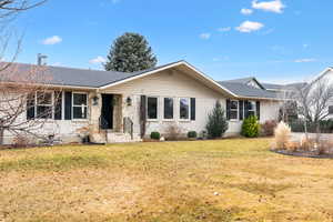 Ranch-style home with a front lawn