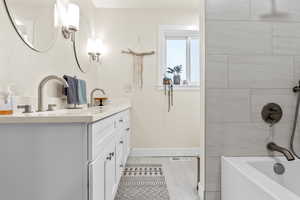 Bathroom with vanity and tiled shower / bath