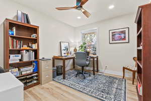 Home office featuring light hardwood / wood-style floors and ceiling fan