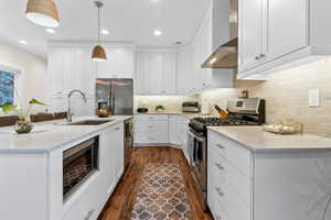 Kitchen featuring sink, appliances with stainless steel finishes, white cabinets, and light stone countertops