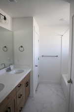 Bathroom with a textured ceiling and vanity