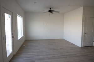 Spare room with light wood-type flooring and ceiling fan