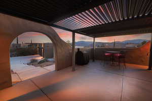 View of patio with a mountain view and outdoor dining area