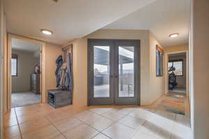 Doorway featuring french doors and light tile patterned floors