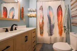 Bathroom featuring tile patterned floors, vanity, and toilet