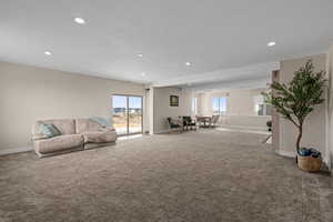 Carpeted living room with a textured ceiling