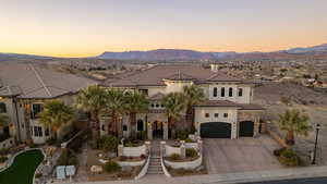 Mediterranean / spanish home featuring a tiled roof, stucco siding, a mountain view, and concrete driveway