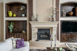 Living room featuring a tiled fireplace