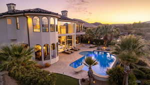 Pool at dusk featuring an outdoor pool and a patio