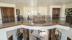 Interior space with a textured ceiling and a high ceiling