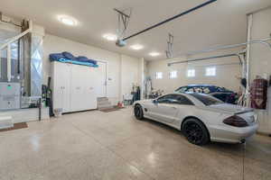 Garage featuring heating unit and a garage door opener