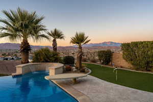 View of swimming pool featuring a fenced in pool, fence, a patio area, and a mountain view