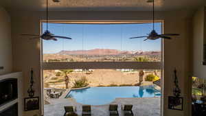 View of swimming pool with ceiling fan and a mountain view