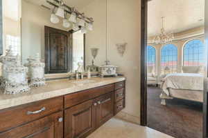 Bathroom featuring visible vents, a notable chandelier, vanity, tile patterned floors, and connected bathroom