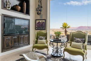 Sitting room with a wealth of natural light, light tile patterned flooring, and a mountain view