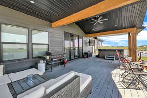 Wooden terrace featuring a grill, ceiling fan, outdoor lounge area, and a hot tub