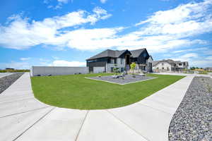 Exterior space with fence, a residential view, and a front lawn