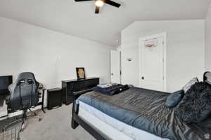 Bedroom featuring ceiling fan, vaulted ceiling, and carpet floors