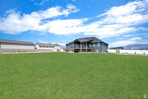 View of yard featuring a mountain view and fence