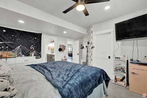 Bedroom with ensuite bath, a ceiling fan, recessed lighting, and carpet floors