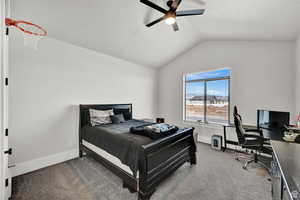 Bedroom featuring baseboards, carpet flooring, a ceiling fan, and lofted ceiling