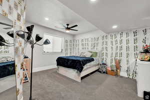 Carpeted bedroom with ceiling fan, baseboards, and recessed lighting