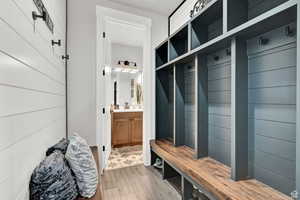 Mudroom featuring a sink and wood finished floors